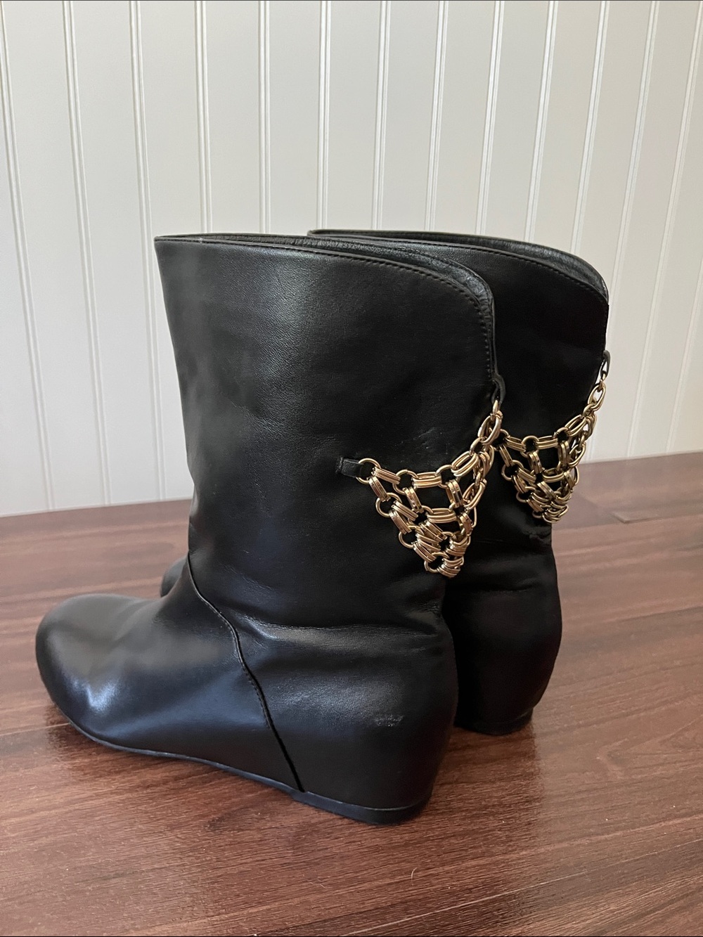 Black Leather Mid-Calf Wedge Boots with Gold Chain Detail